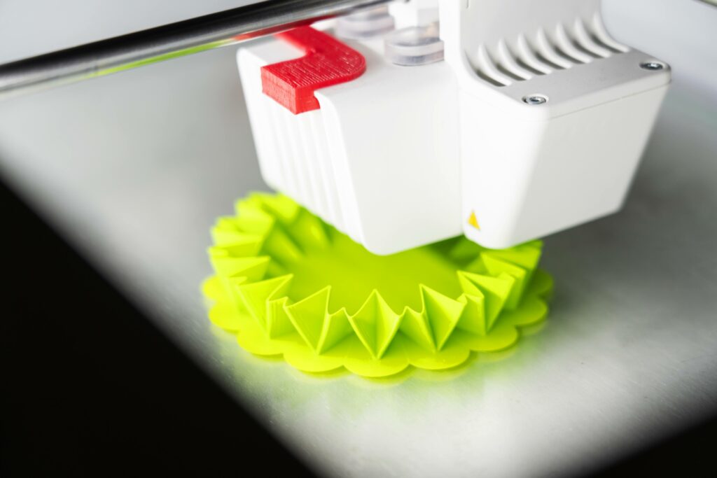 An Ultimaker 3D printer printing a green object